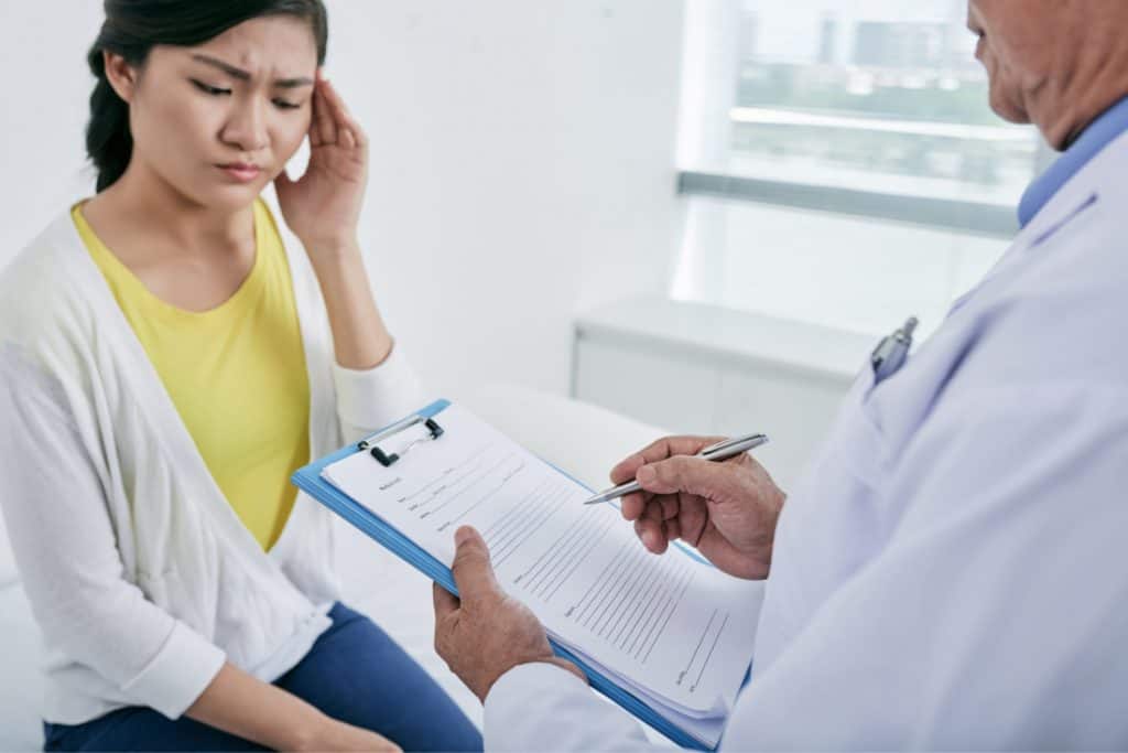 Woman talking to doctor about migraine treatment