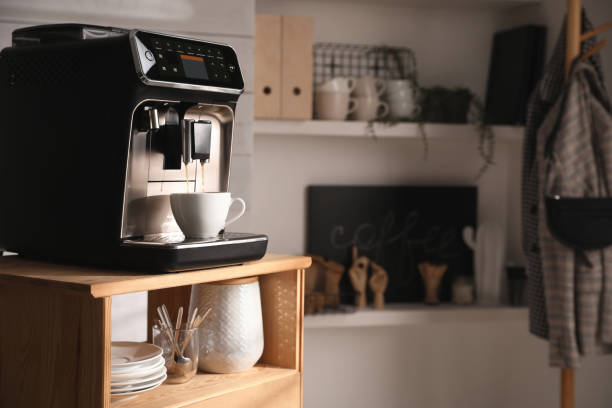 Coffee Station Goals: How to Create a Café Vibe at Home 2 Automatic coffee machine dispensing coffee into a white cup on a wooden cart, creating a cozy café vibe at home, with shelves holding mugs and kitchen items in the background.